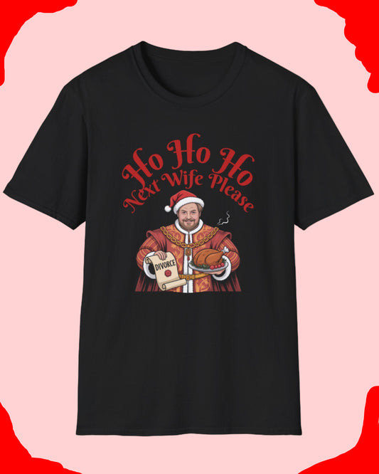 Black t-shirt with a graphic design featuring a man in a Santa suit and text 'Ho Ho Ho New Wife Please' on a white background.