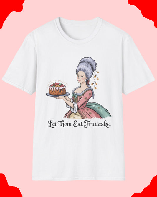 White t-shirt with a graphic of a woman holding a fruitcake and text 'Let Them Eat Fruitcake' on a white background.