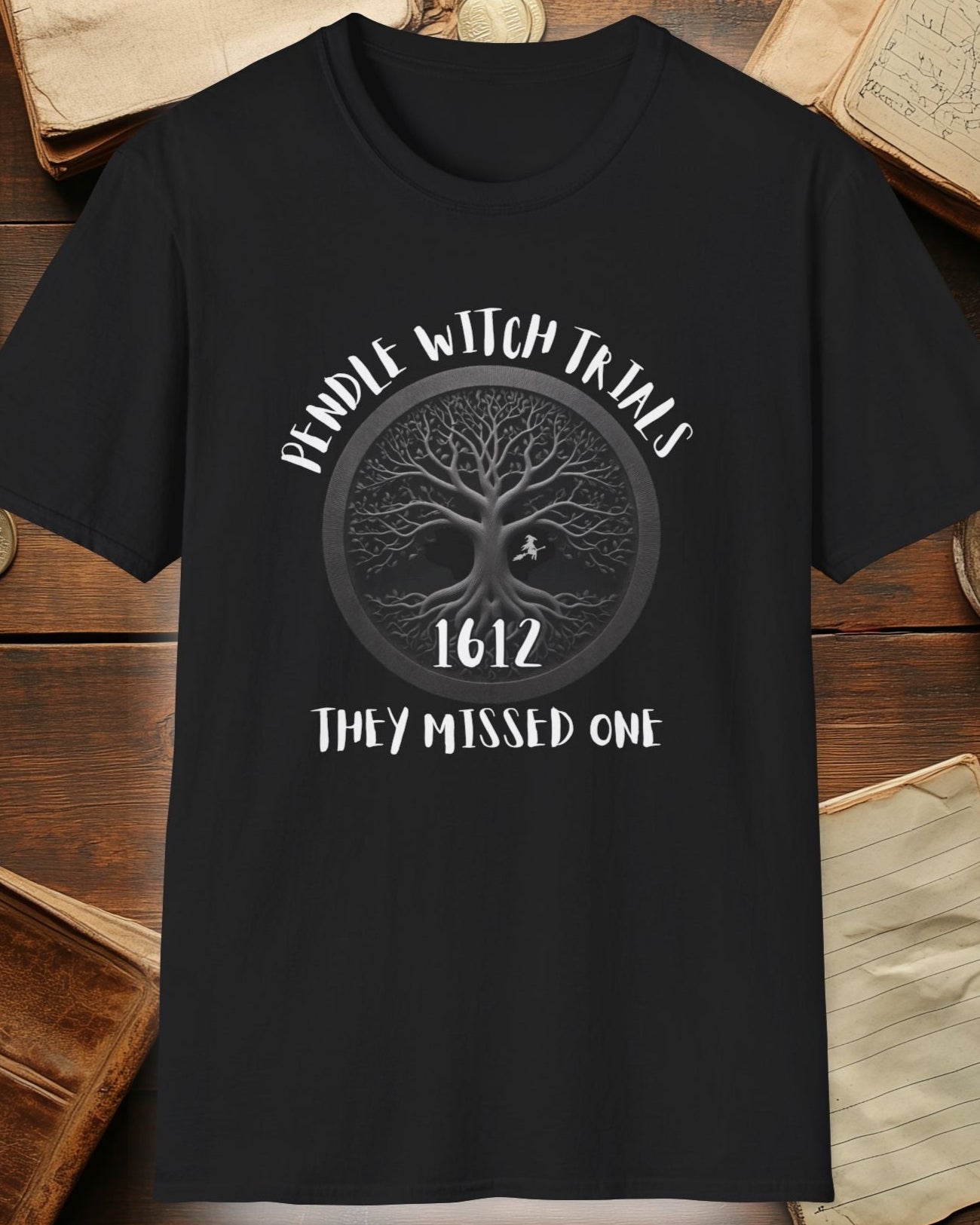 black tshirt with the text "Pendle witch trials, they missed one"