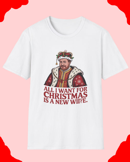 White t-shirt with a graphic of a man in a crown and text 'All I want for Christmas is a new wife.' on a white background.