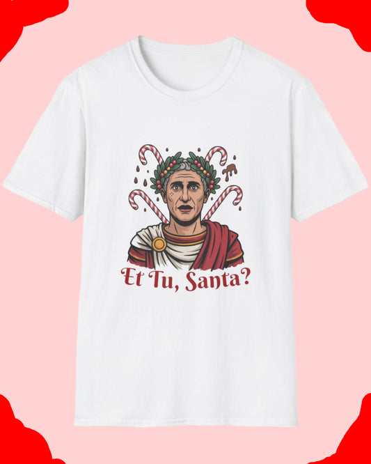White t-shirt with a graphic design of a person wearing a wreath and candy canes, with 'Et Tu, Santa?' text on a white background.