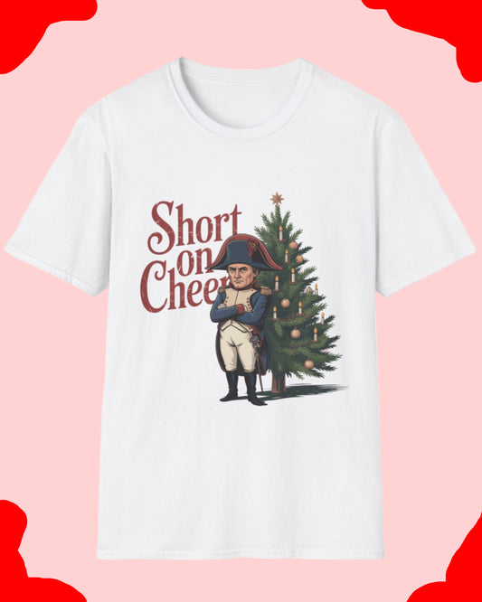 White t-shirt with a graphic of a person next to a Christmas tree and 'Short on Cheer' text on a white background