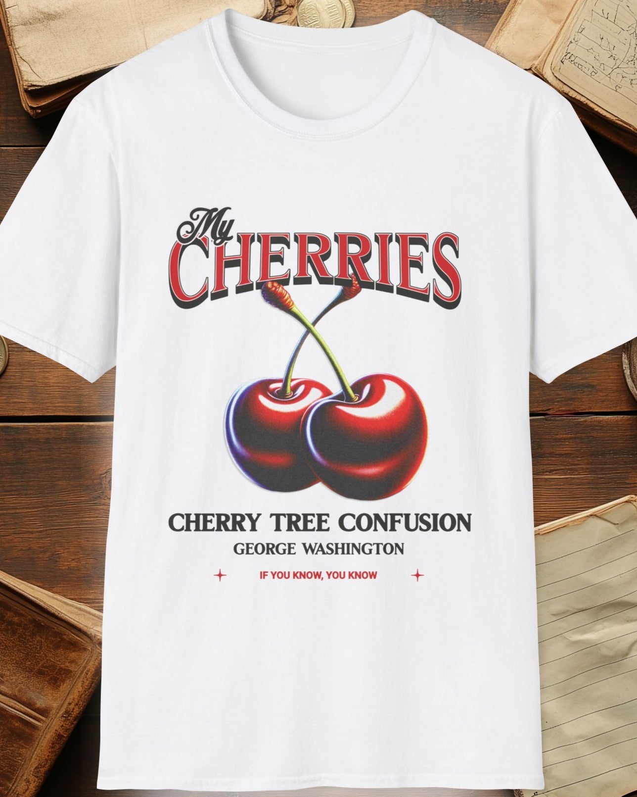white tshirt with charries and the text "The cherries, cherry tree confusion"