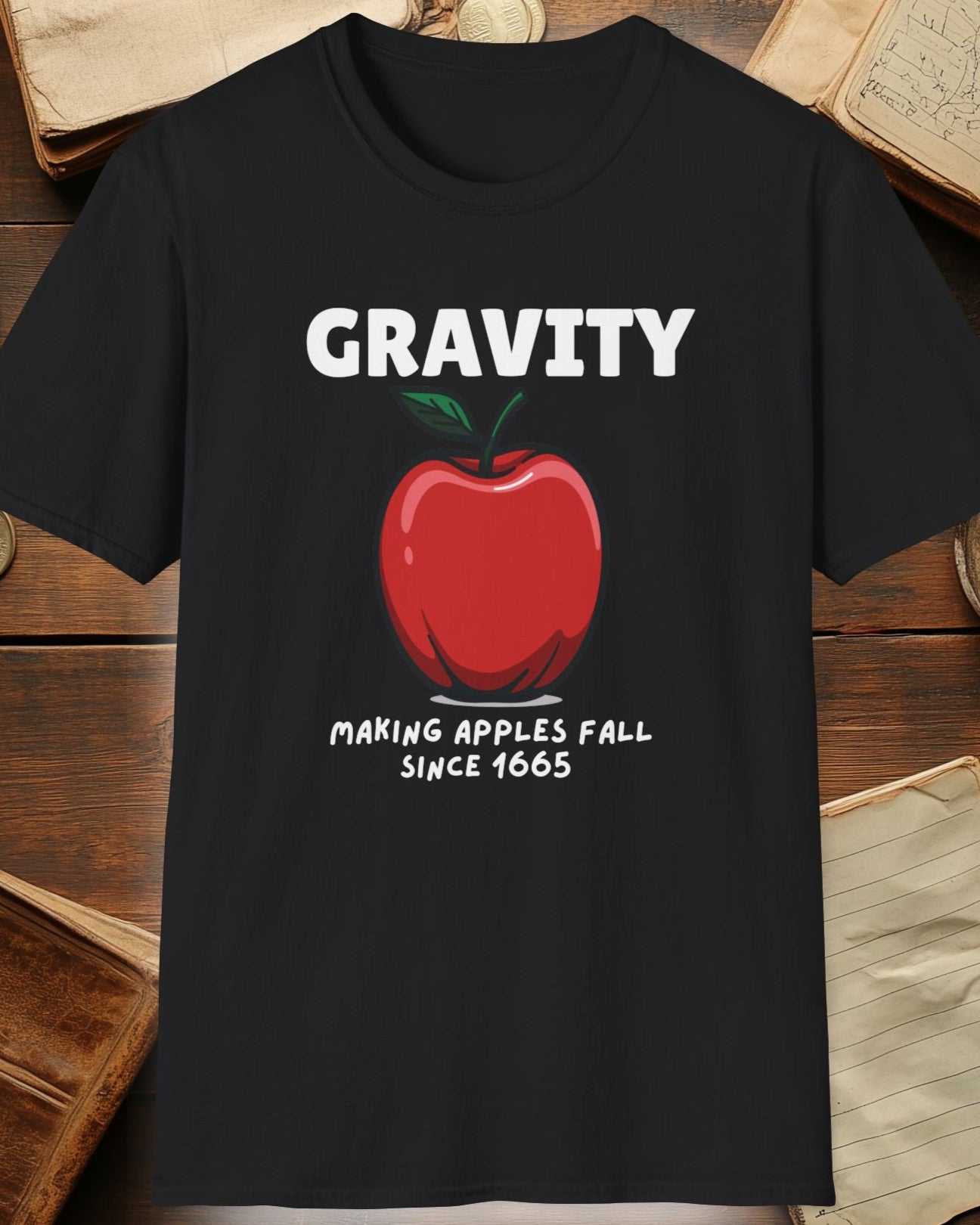 black tshirt with a apple and the text "Gravity, Making apples fall since 1665"
